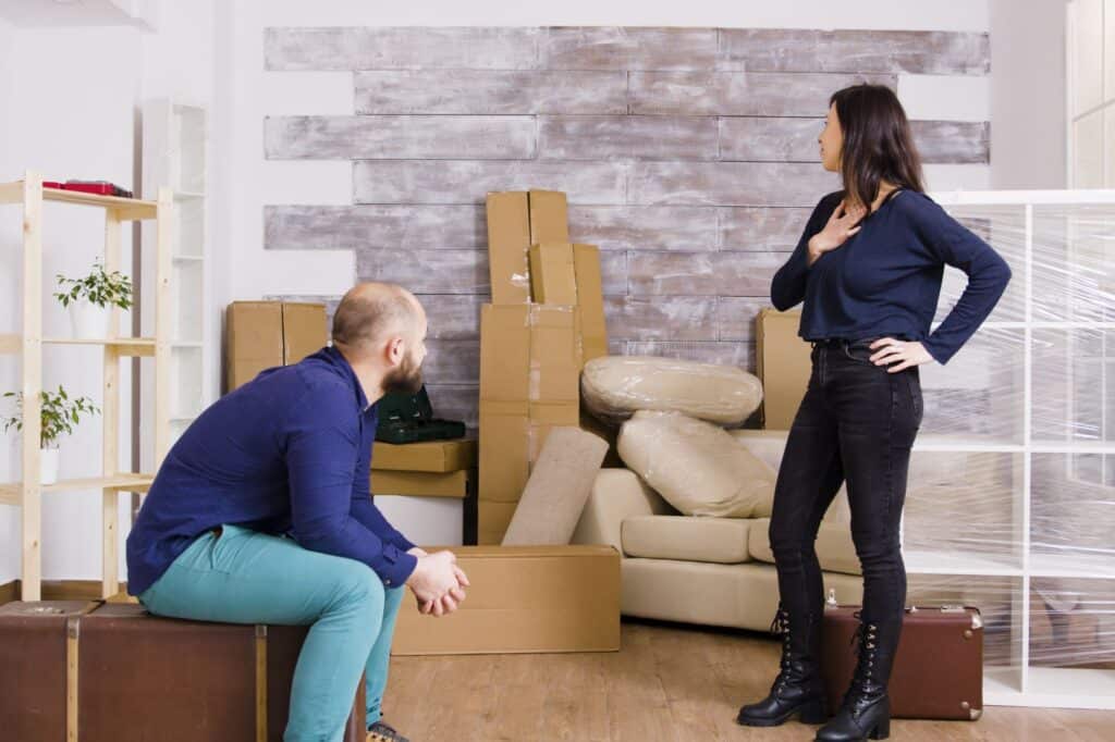 A couple arriving in their new home full of boxes