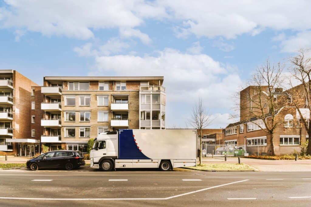 A moving truck outside the block of flats