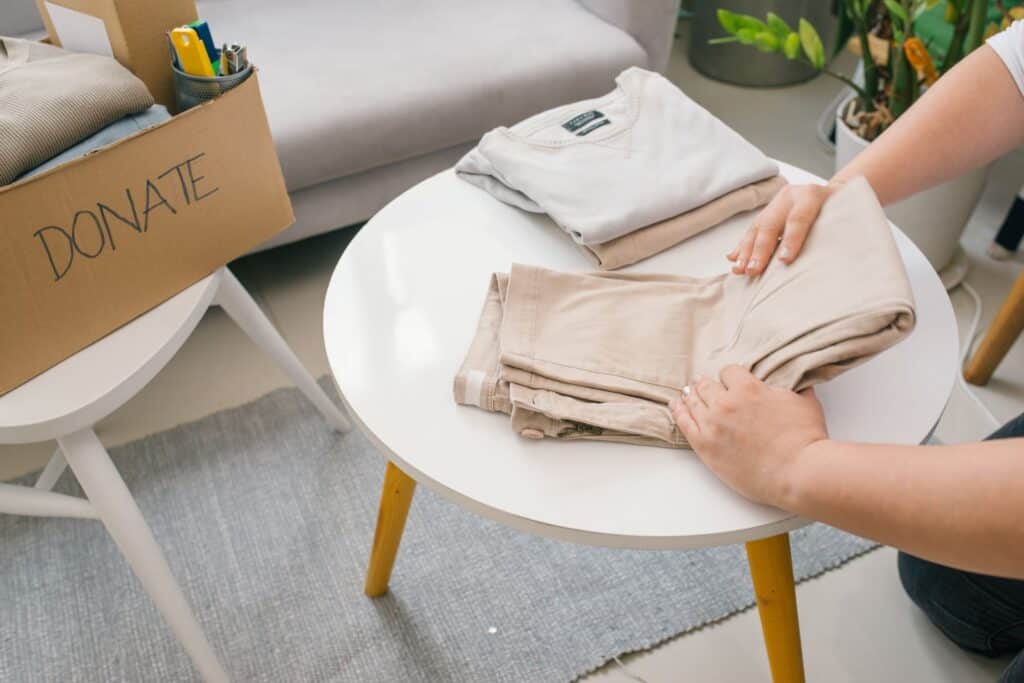 A woman preparing old clothes for donation