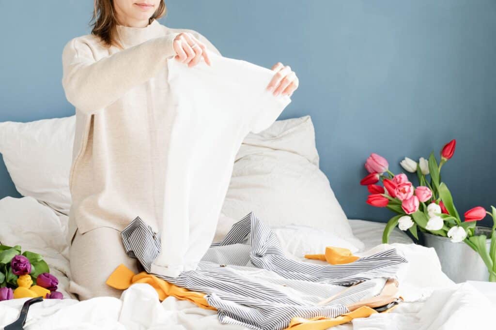 A young woman organizing clothes