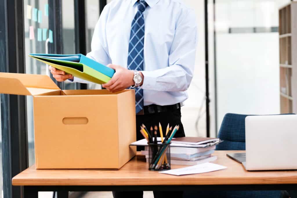 A man in the office is packing his office stuff in the concept of office move in Harrow