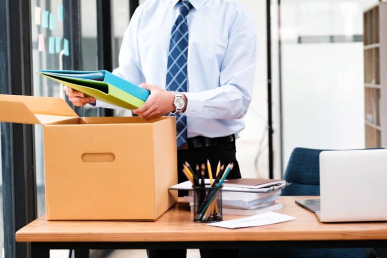 A man in the office is packing his office stuff in the concept of office move in Harrow