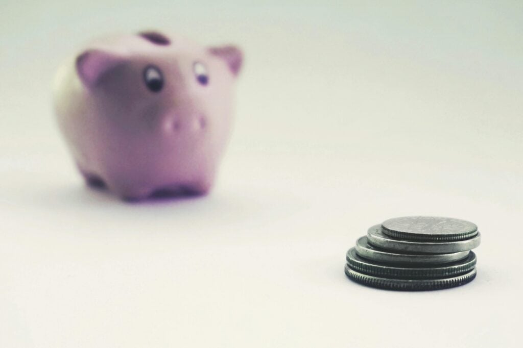 A stack of coins and piggy bank in the concept of saving money when moving to Harrow.