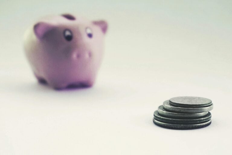 A stack of coins and piggy bank in the concept of saving money when moving to Harrow.