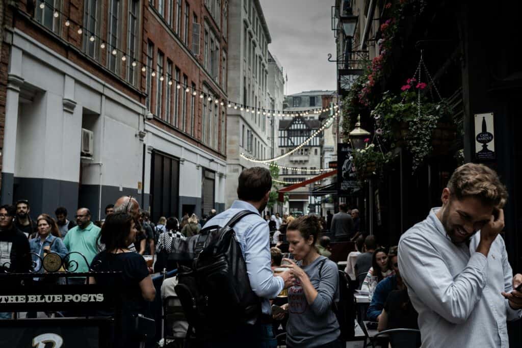 People in a street full of dining options
