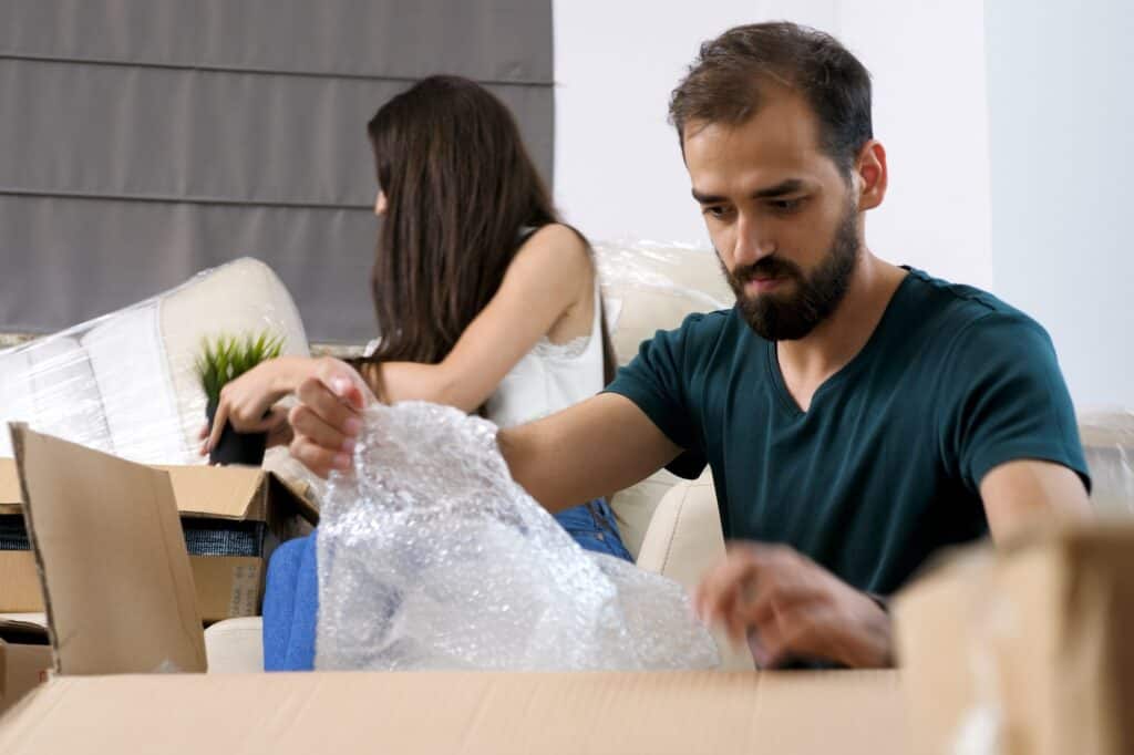 A young couple unpacking boxes after moving in