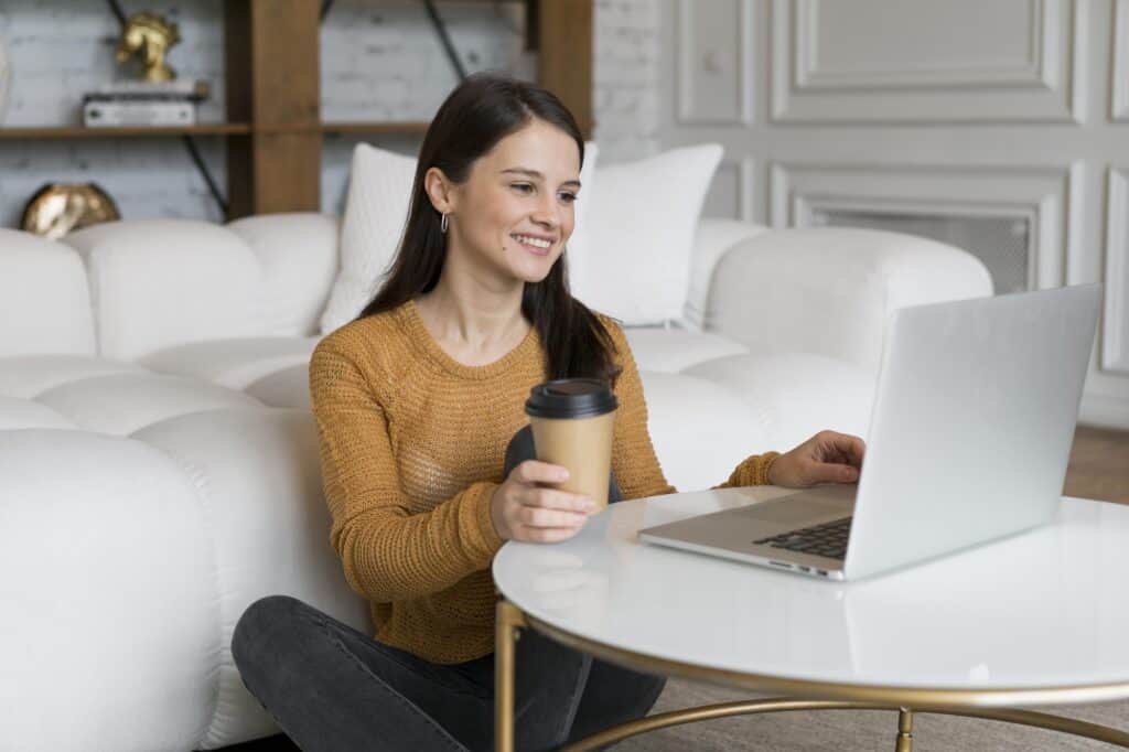 A young woman researching moving companies in the computer