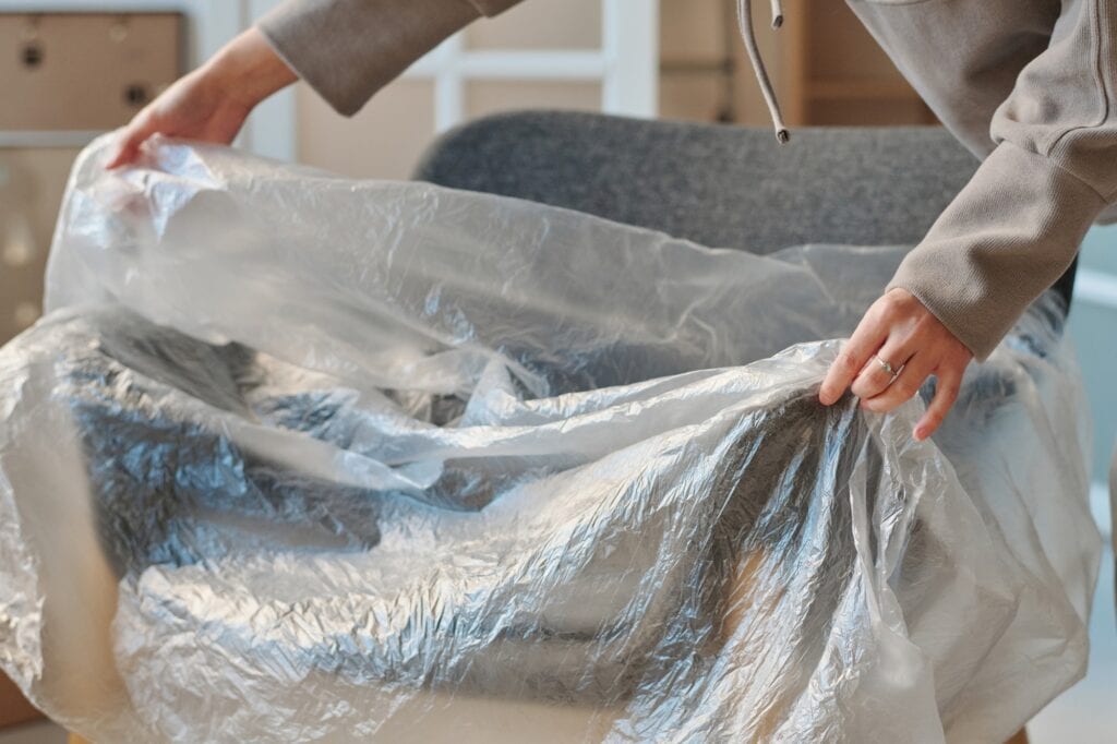 Closeup of a chair wrapped with plastic for the house move